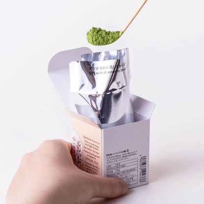 Ippodo Tea Kan matcha tin with lid open showing green powder